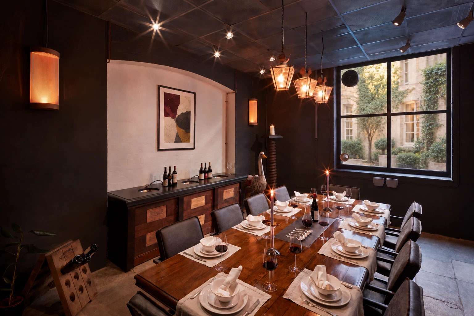 A generous dining table prepared for an intimate evening, with warm lighting and a courtyard view.